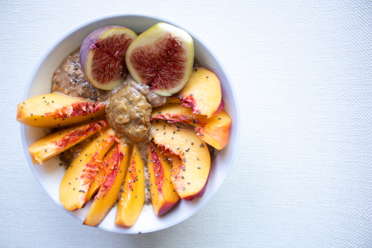 Quinoa breakfast bowl with roasted vegetables, seeds, and tahini drizzle